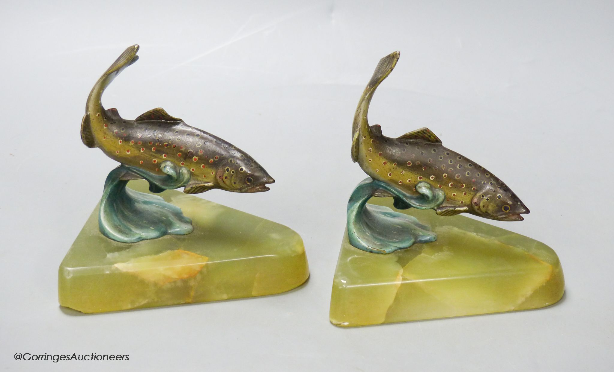 A pair of cold painted bronze fish bookends, on onyx bases, height 12cm